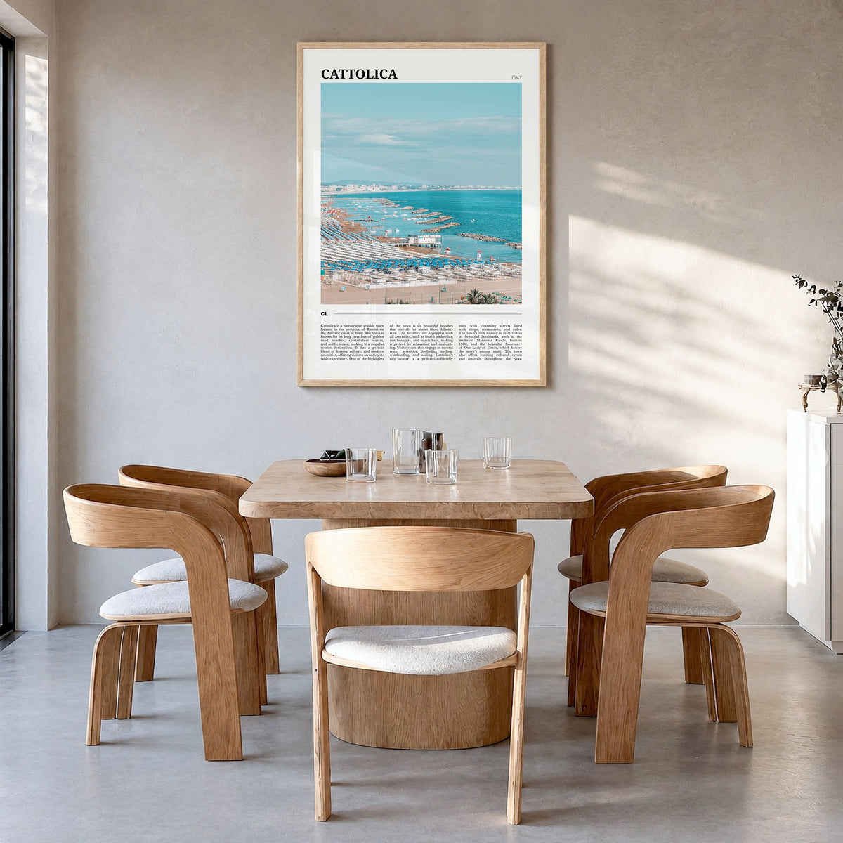 Cattolica Travel Poster in a natural wood frame, hanging in a dining room