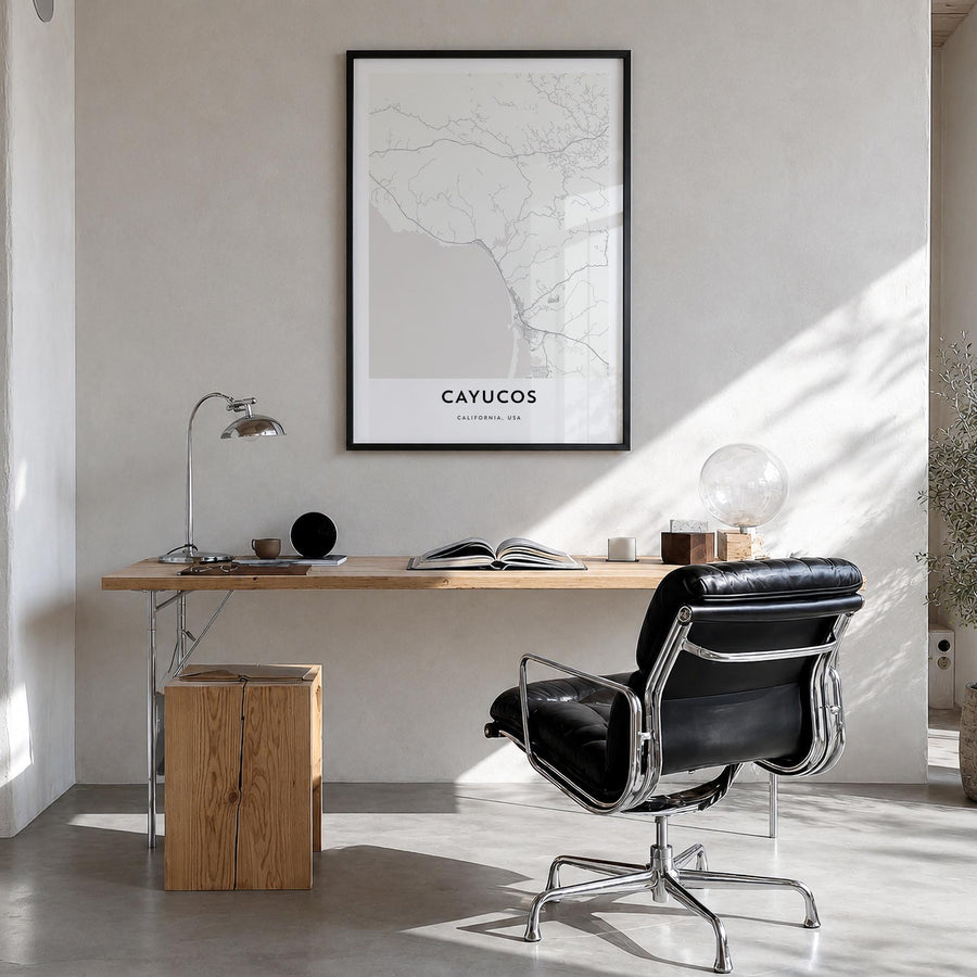 Cayucos black & white map poster of California, USA – vertical wall art in black wood frame, hanging on wall