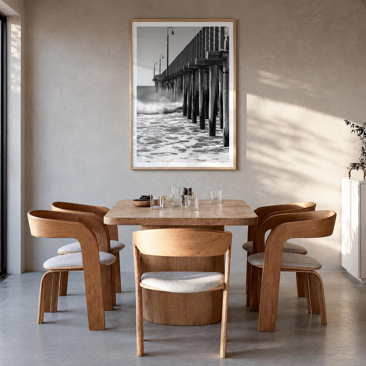 Cayucos black & white photo poster of California, USA – vertical wall art in natural wood frame with white border, hanging on