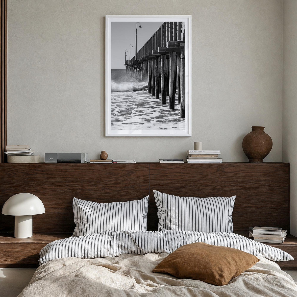 Cayucos black & white photo poster of California, USA – vertical wall art in white wood frame with white border, hanging on w