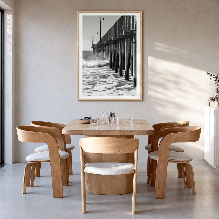 Cayucos Photo Poster in a natural wood frame, hanging in a dining room, white border