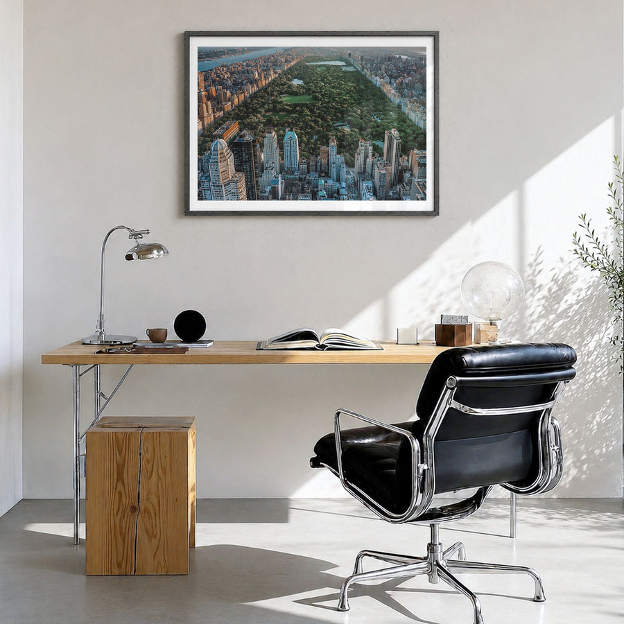 Central Park Photo Poster in a black wood frame, hanging in a bright home office, white border