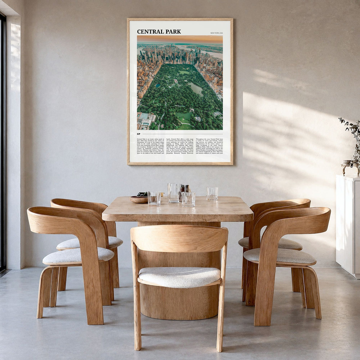 Central Park Travel Poster in a natural wood frame, hanging in a dining room