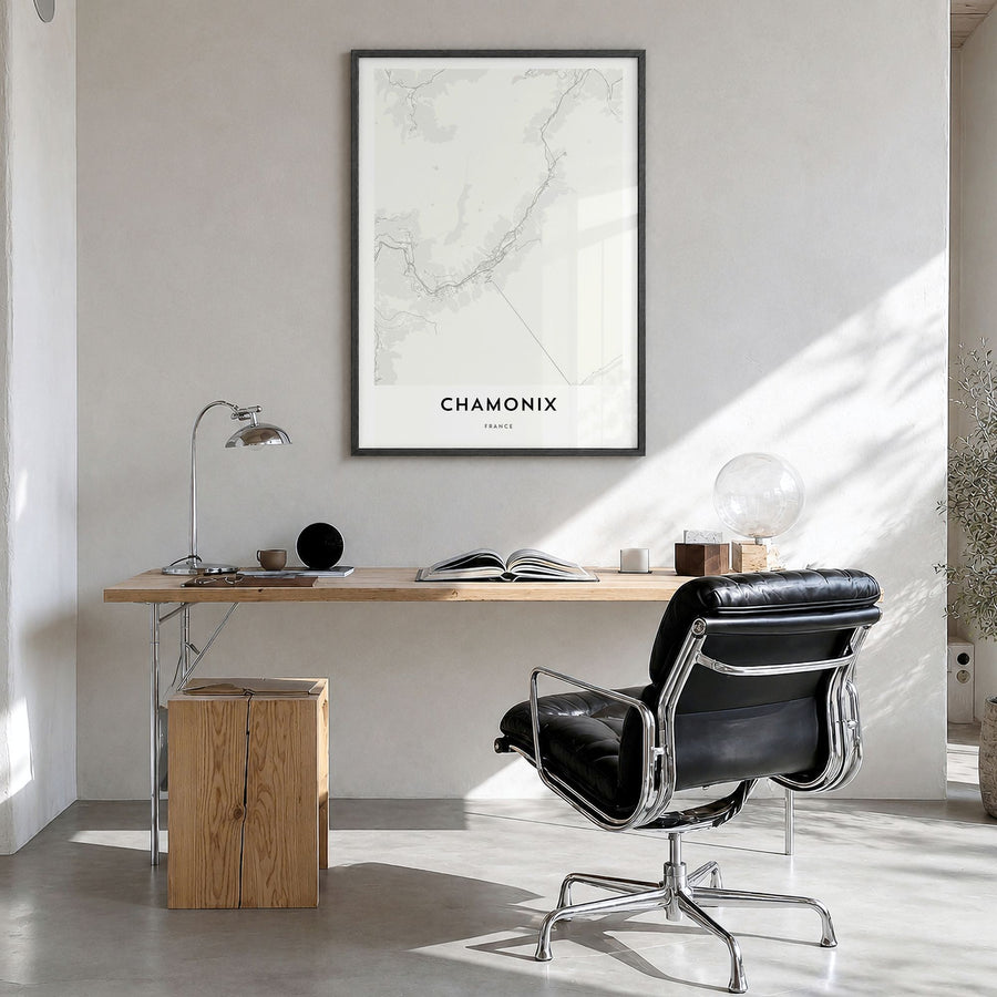 Chamonix Map Poster in a black wood frame, hanging in a bright home office