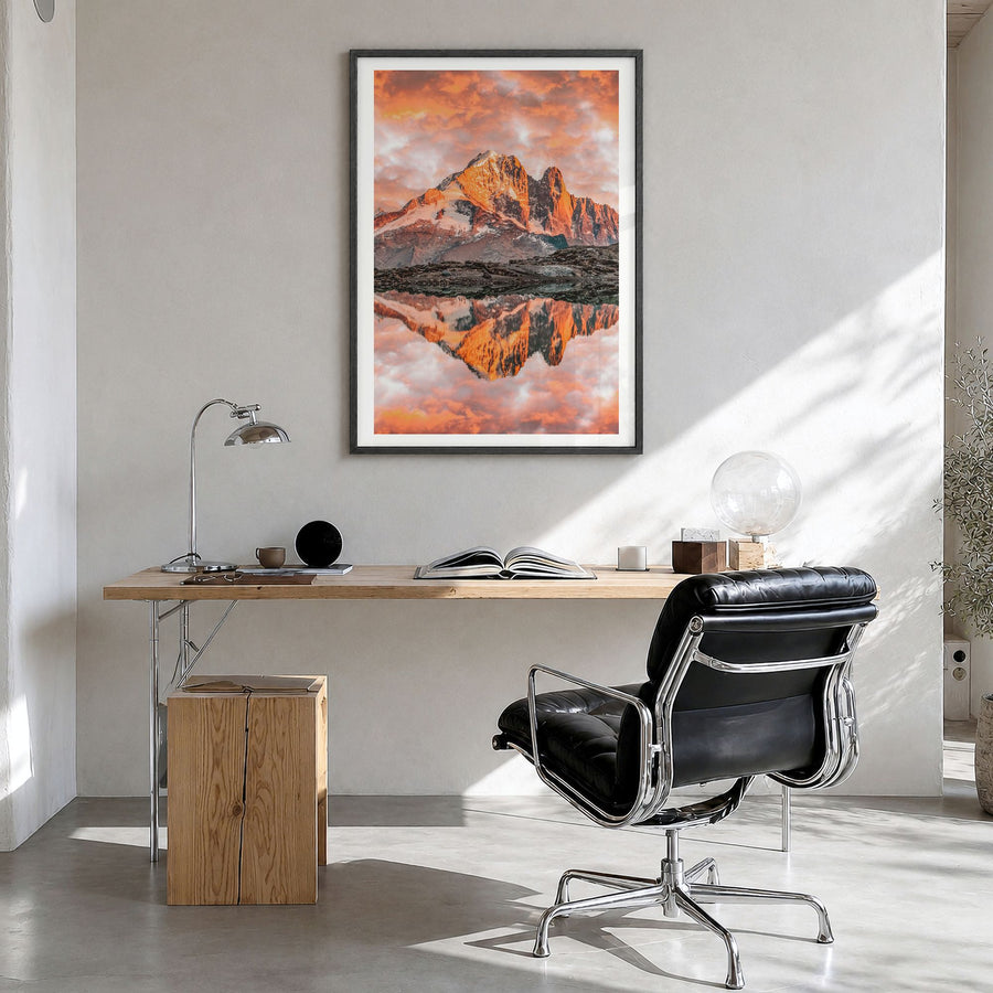 Chamonix Photo Poster in a black wood frame, hanging in a bright home office, white border
