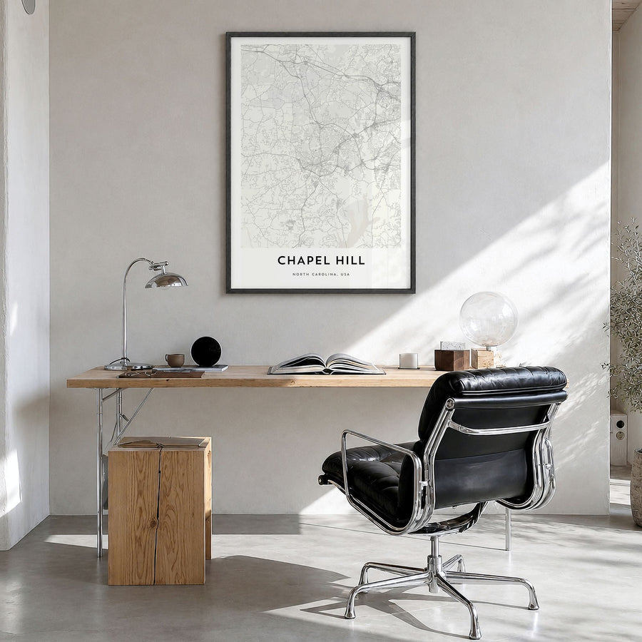 Chapel Hill Map Poster in a black wood frame, hanging in a bright home office