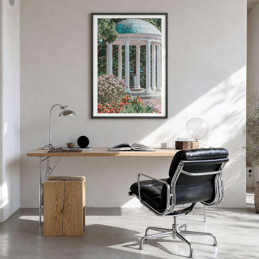 Chapel Hill Photo Poster in a black wood frame, hanging in a bright home office, white border