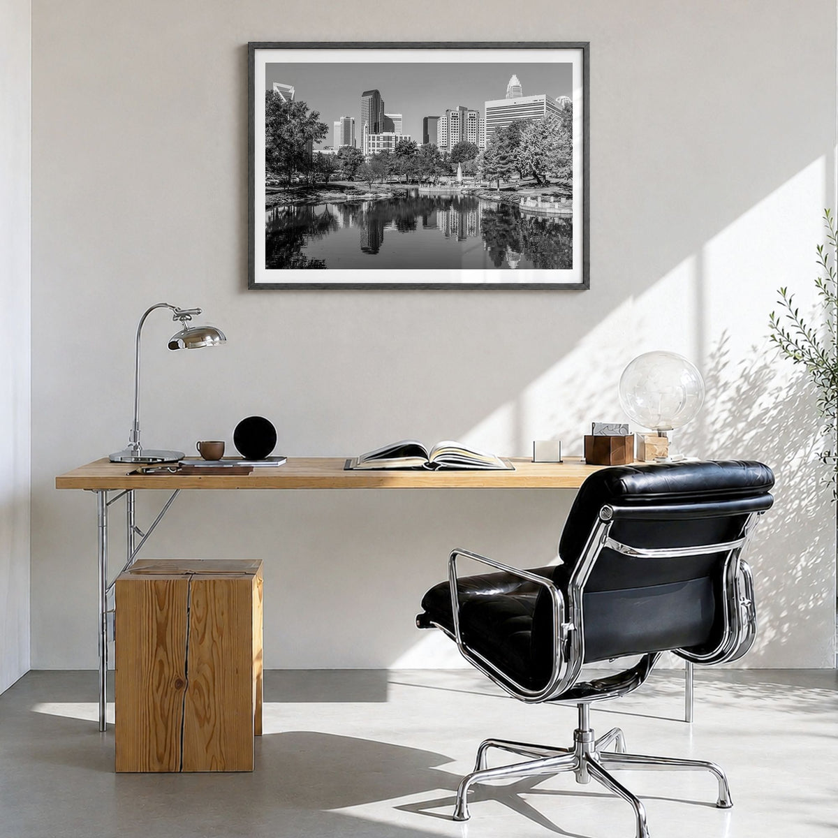 Charlotte Photo Poster in a black wood frame, hanging in a bright home office, white border