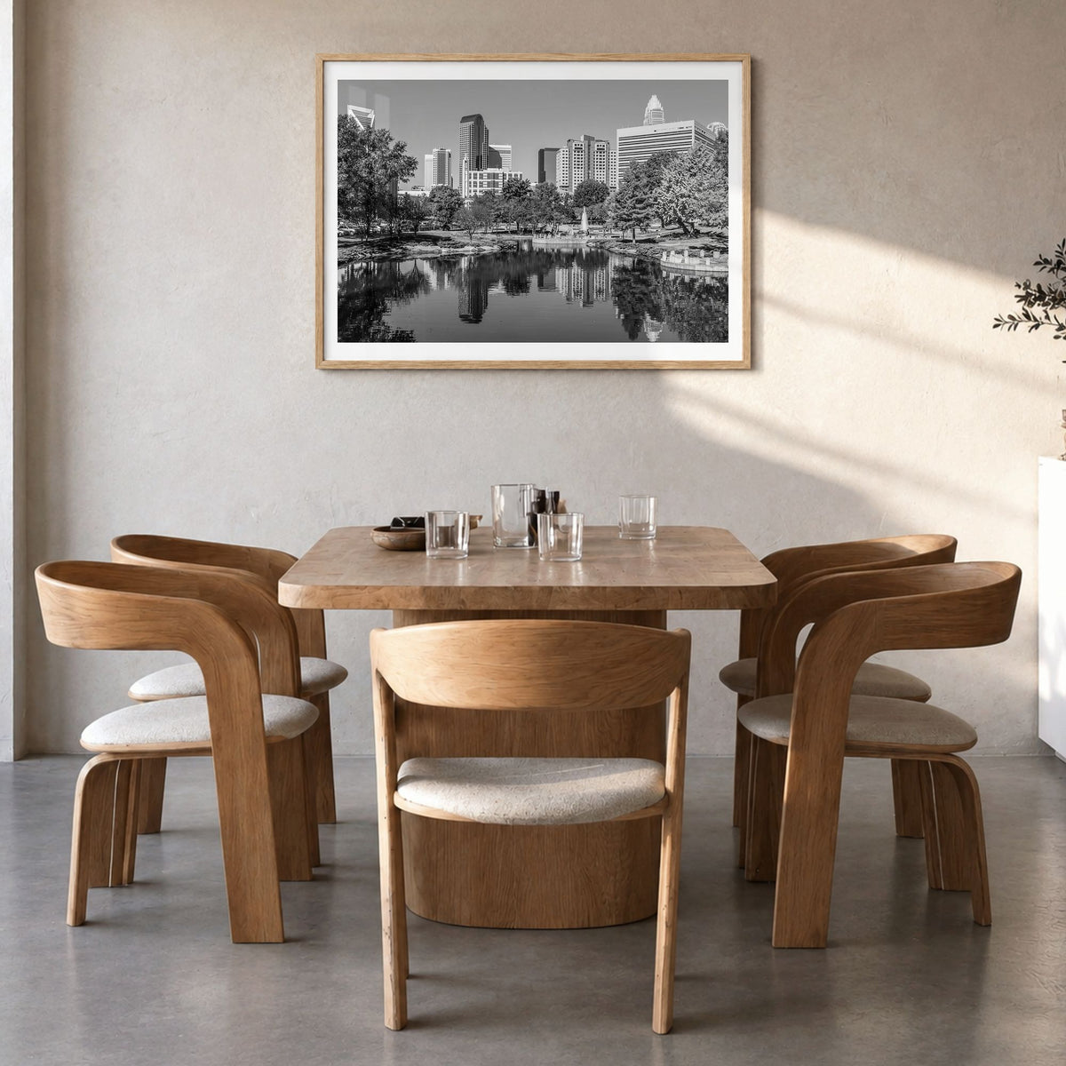 Charlotte Photo Poster in a natural wood frame, hanging in a dining room, white border