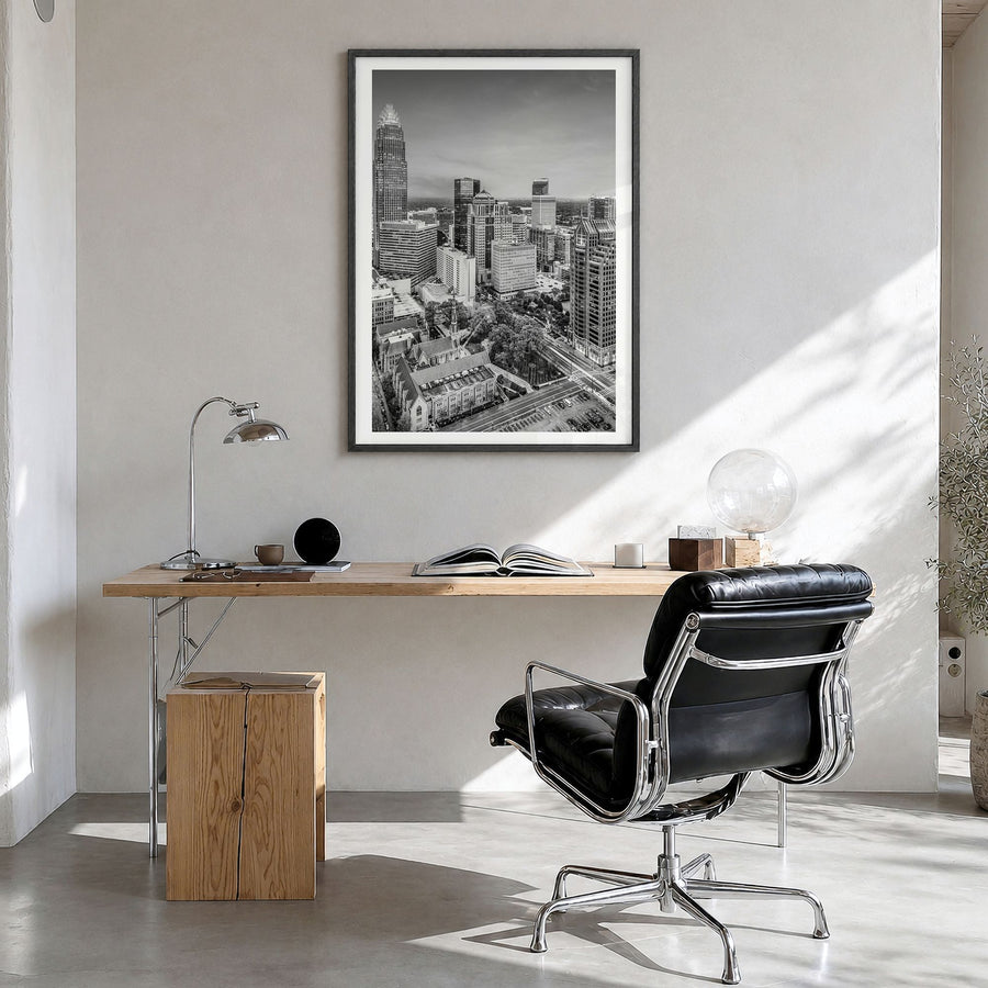 Charlotte Photo No 1 Poster in a black wood frame, hanging in a bright home office, white border