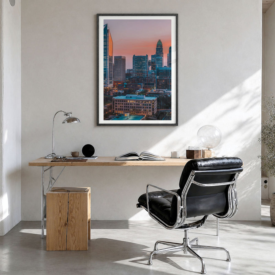 Charlotte Photo No 2 Poster in a black wood frame, hanging in a bright home office, white border