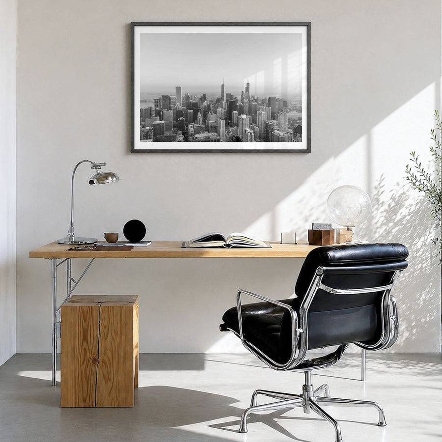 Chicago Photo No 1 Poster in a black wood frame, hanging in a bright home office, white border