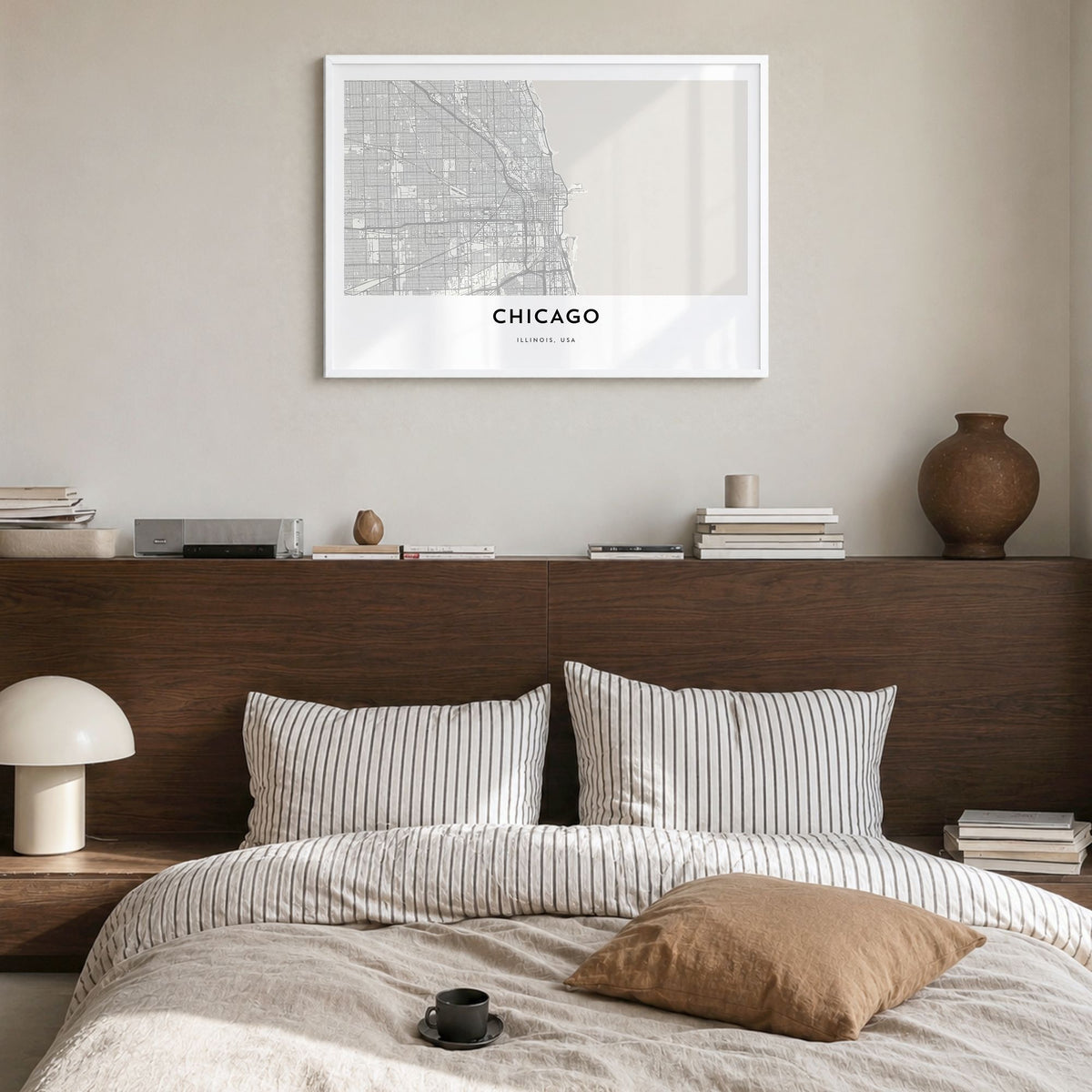 Chicago Map Poster in a white wood frame, hanging in a bedroom