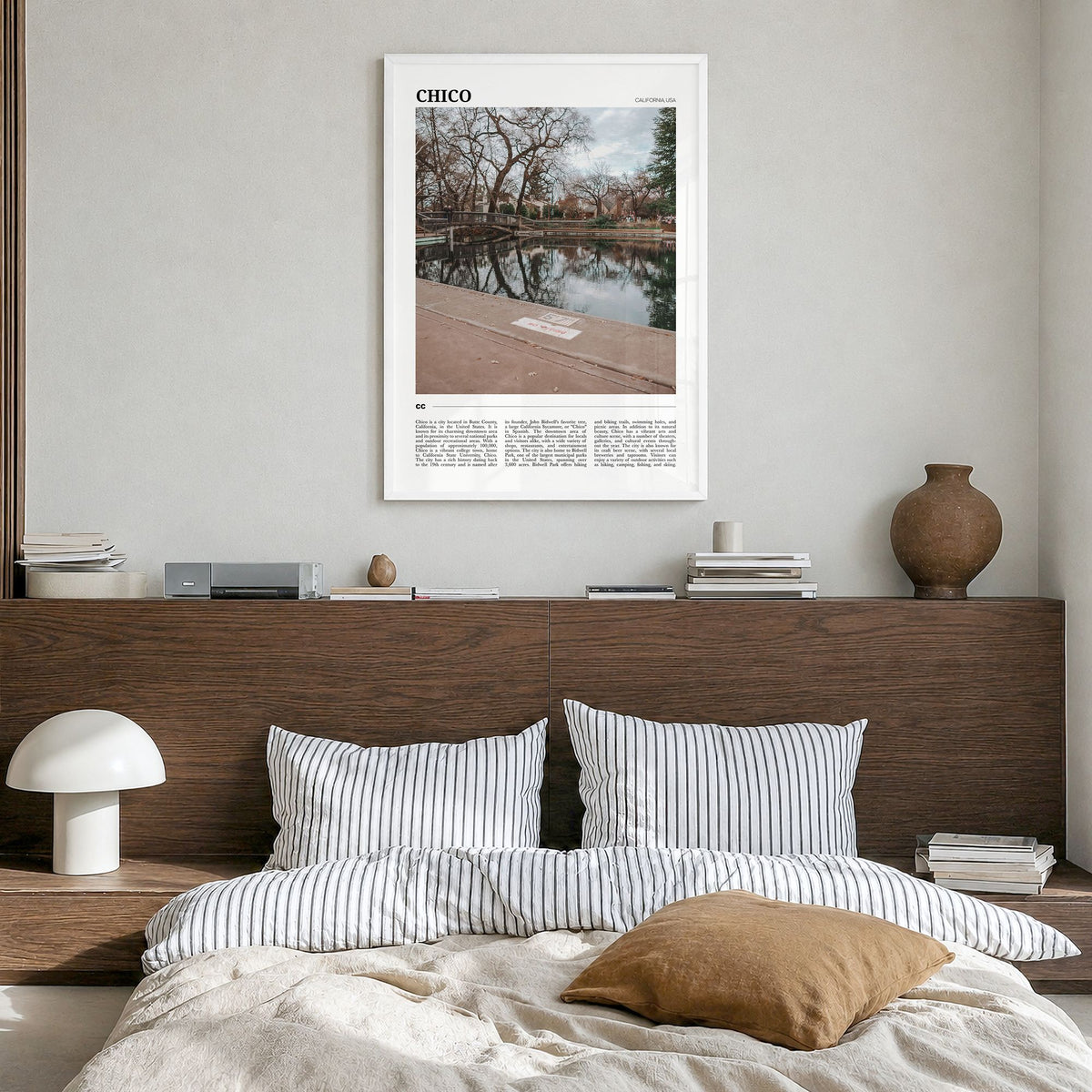 Chico Travel Poster in a white wood frame, hanging in a bedroom