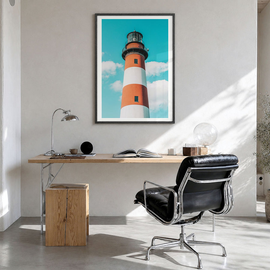 Chincoteague Photo Poster in a black wood frame, hanging in a bright home office, white border