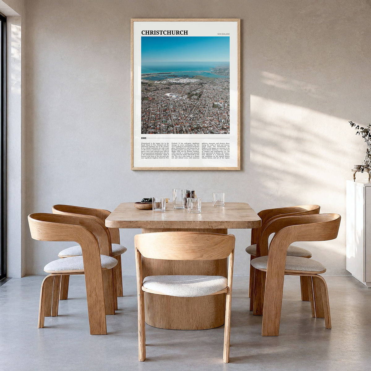 Christchurch Travel Poster in a natural wood frame, hanging in a dining room