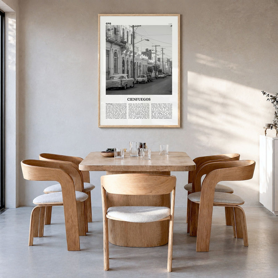 Cienfuegos Newspaper Poster in a natural wood frame, hanging in a dining room