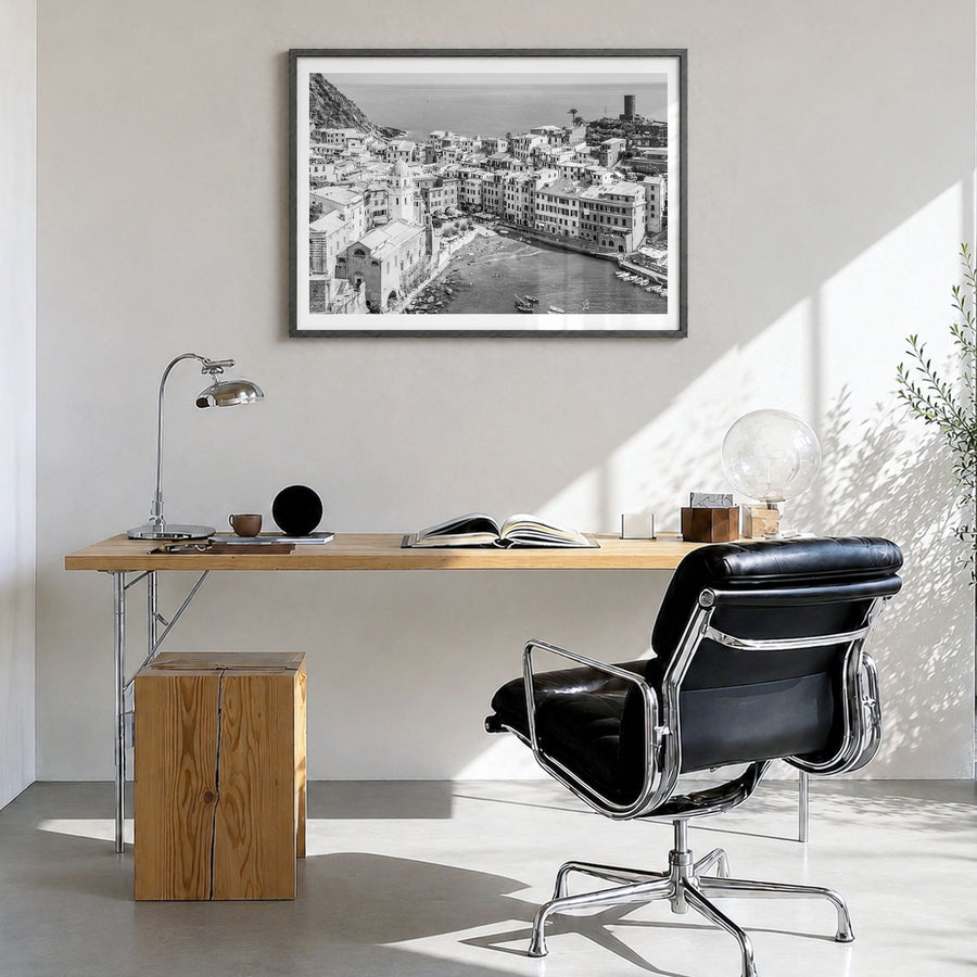 Cinque Terre Photo Poster in a black wood frame, hanging in a bright home office, white border