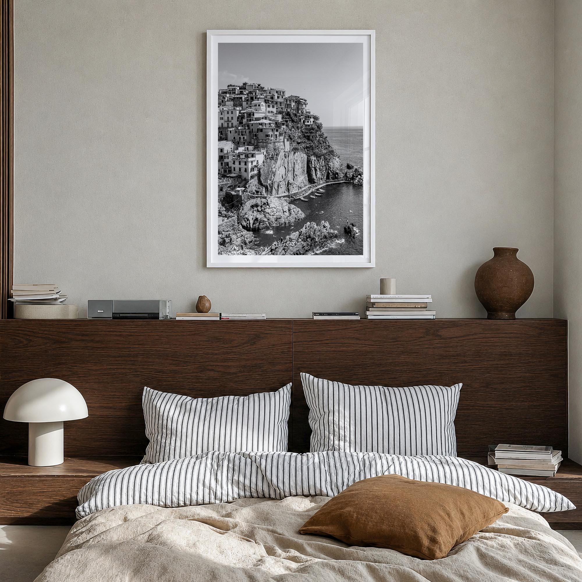 Cinque Terre no. 1 black & white photo poster of Italy – vertical wall art in white wood frame with white border, hanging on 