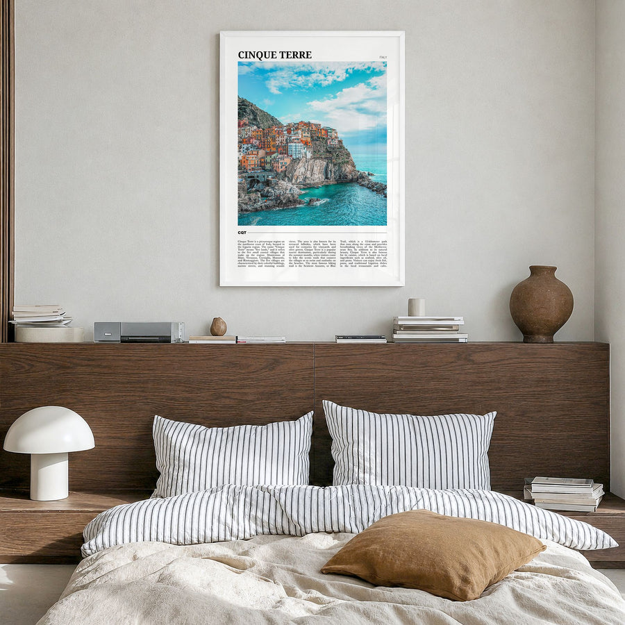 Cinque Terre Travel Poster in a white wood frame, hanging in a bedroom