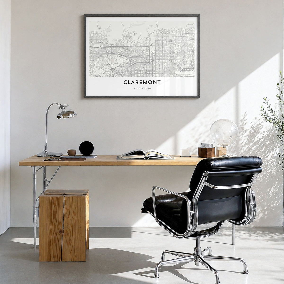 Claremont Map Poster in a black wood frame, hanging in a bright home office