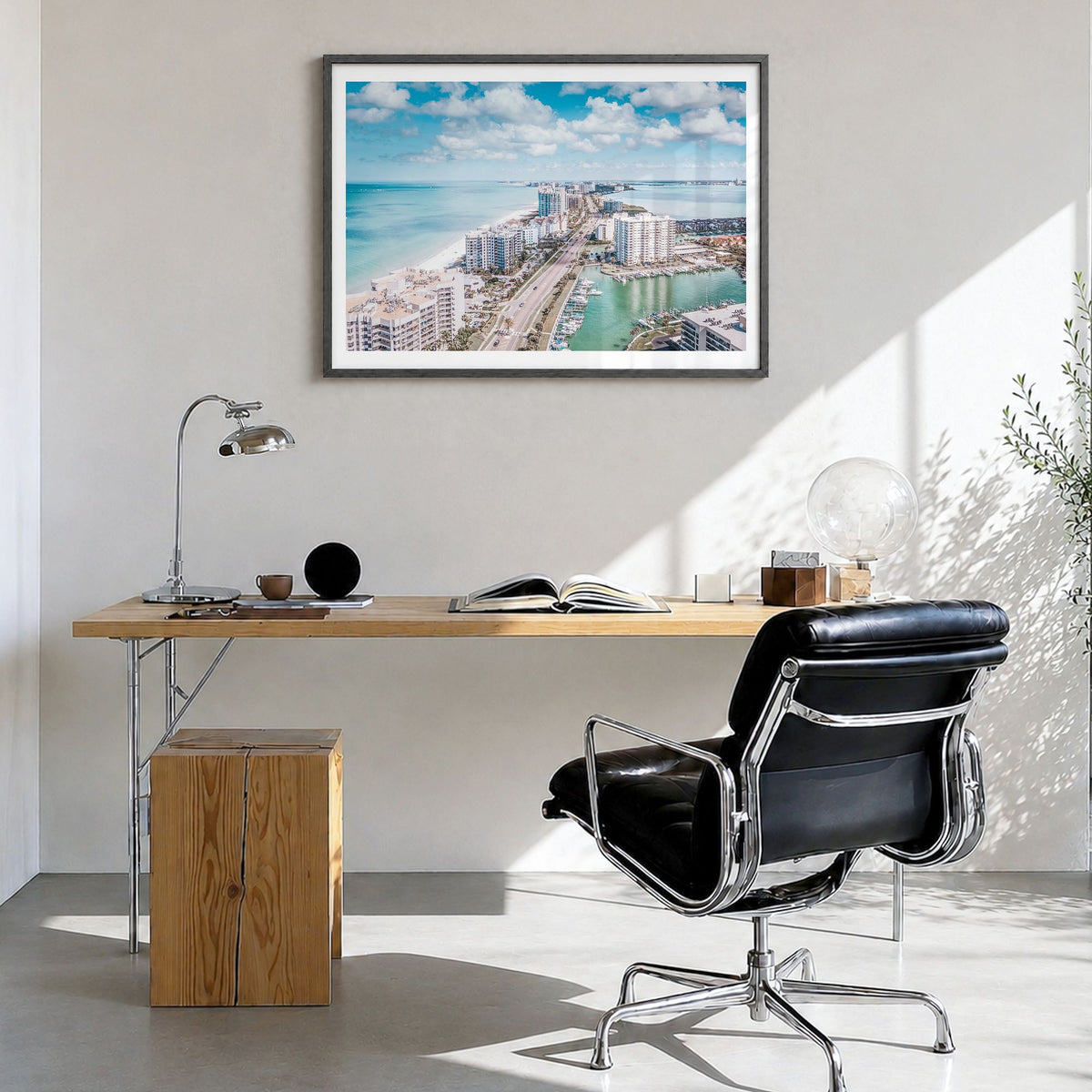 Clearwater Photo Poster in a black wood frame, hanging in a bright home office, white border