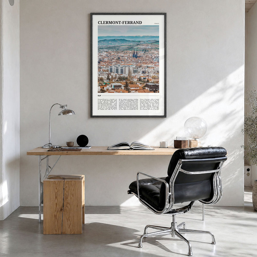 Clermont-Ferrand Travel Poster in a black wood frame, hanging in a bright home office
