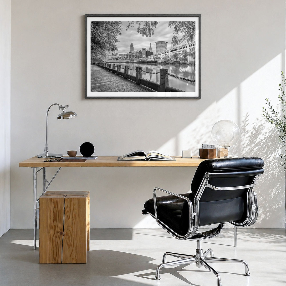 Cleveland Photo Poster in a black wood frame, hanging in a bright home office, white border