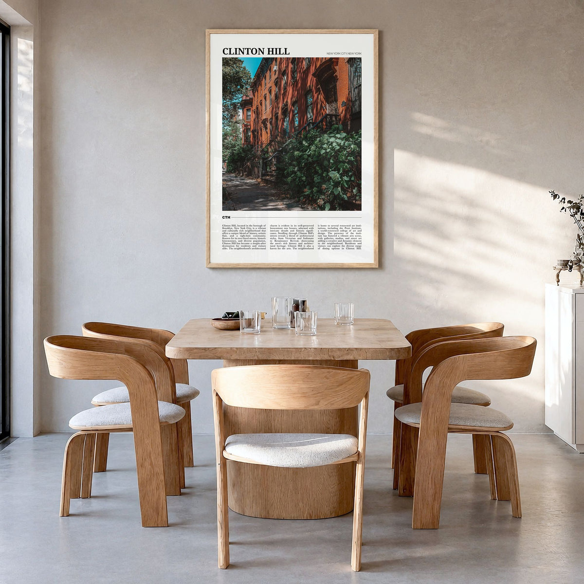 Clinton Hill Travel Poster in a natural wood frame, hanging in a dining room