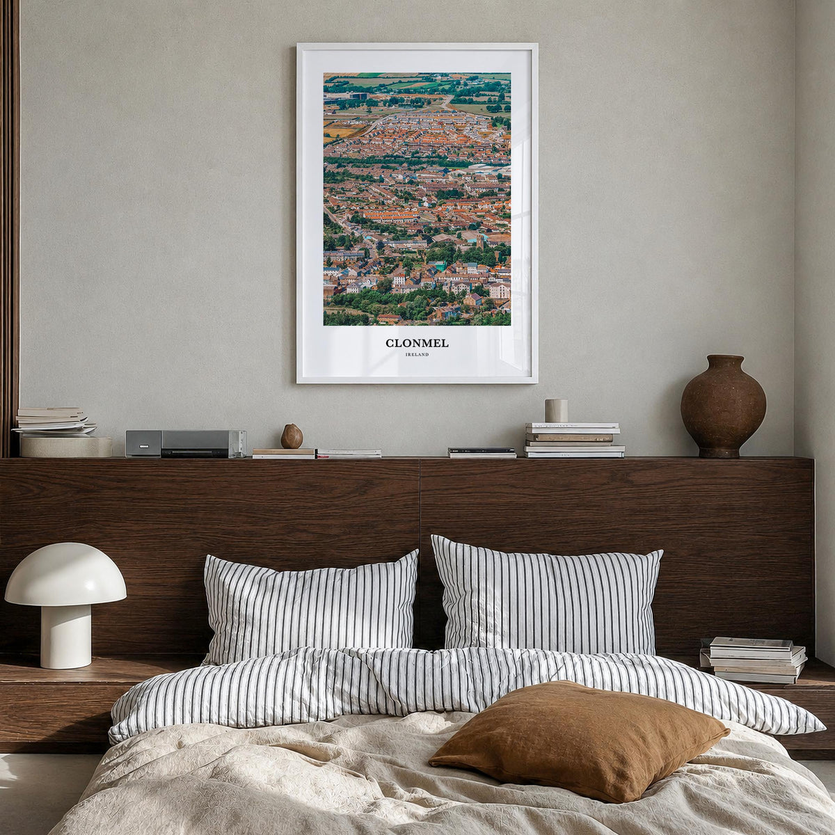 Clonmel colorful classic poster of Ireland – vertical wall art in white wood frame, hanging on wall