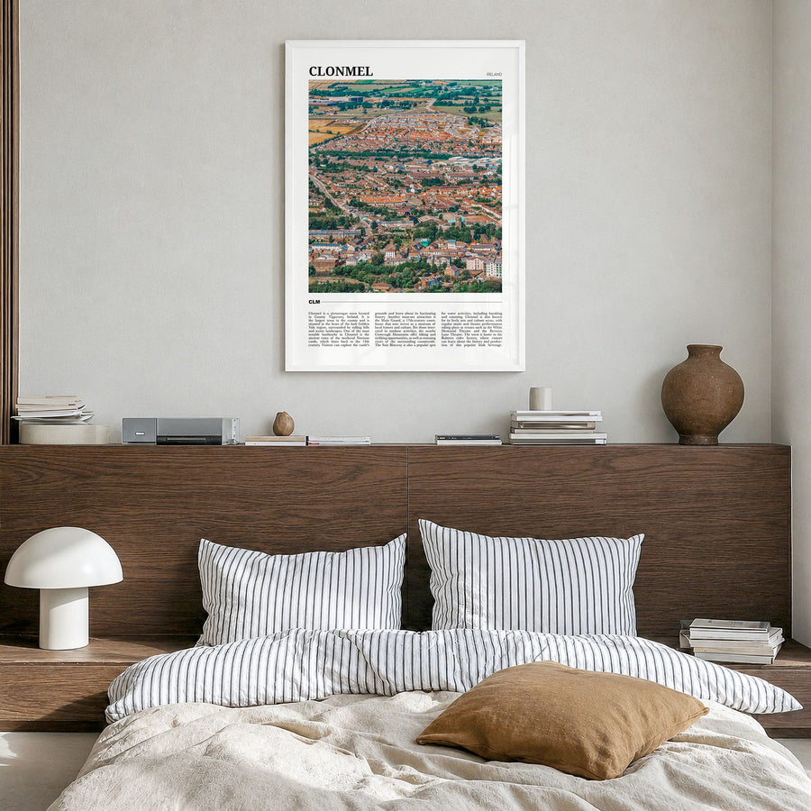 Clonmel Travel Poster in a white wood frame, hanging in a bedroom