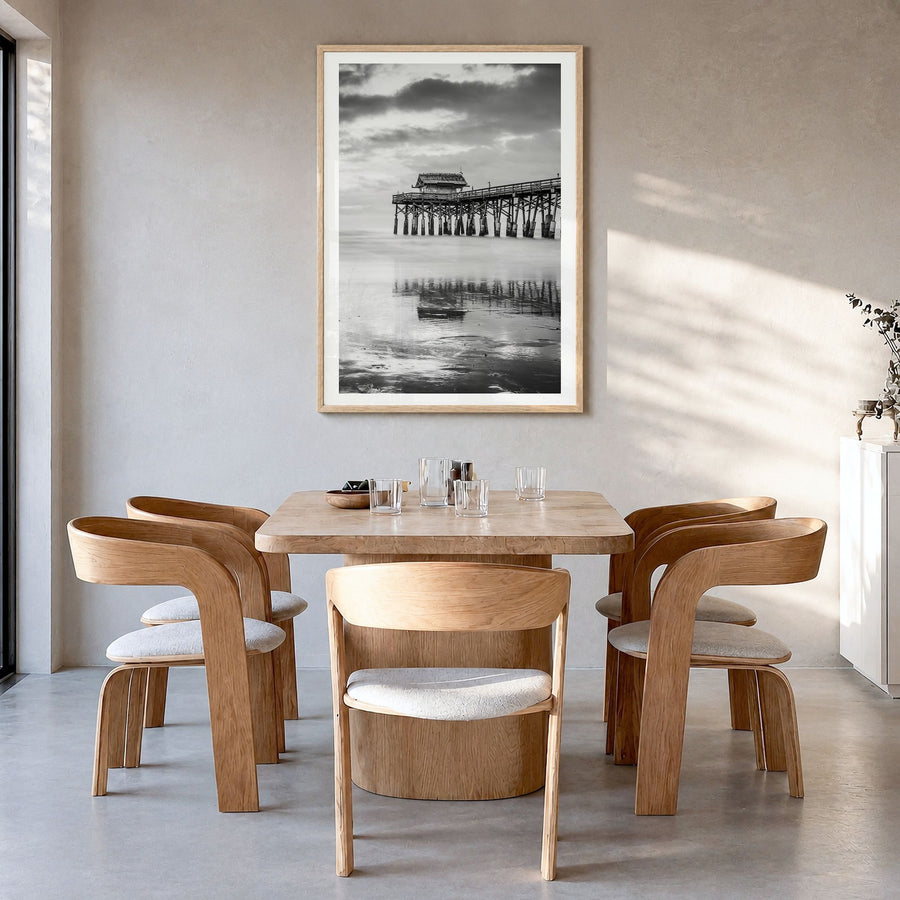 Cocoa Beach Photo Poster in a natural wood frame, hanging in a dining room, white border