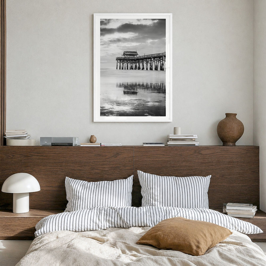 Cocoa Beach Photo Poster in a white wood frame, hanging in a bedroom, white border