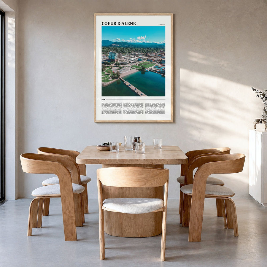 Coeur d'Alene Travel Poster in a natural wood frame, hanging in a dining room