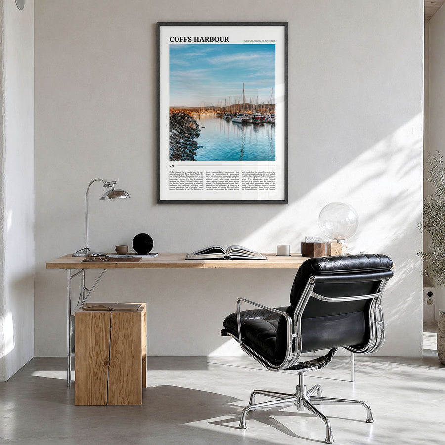 Coffs Harbour Travel Poster in a black wood frame, hanging in a bright home office