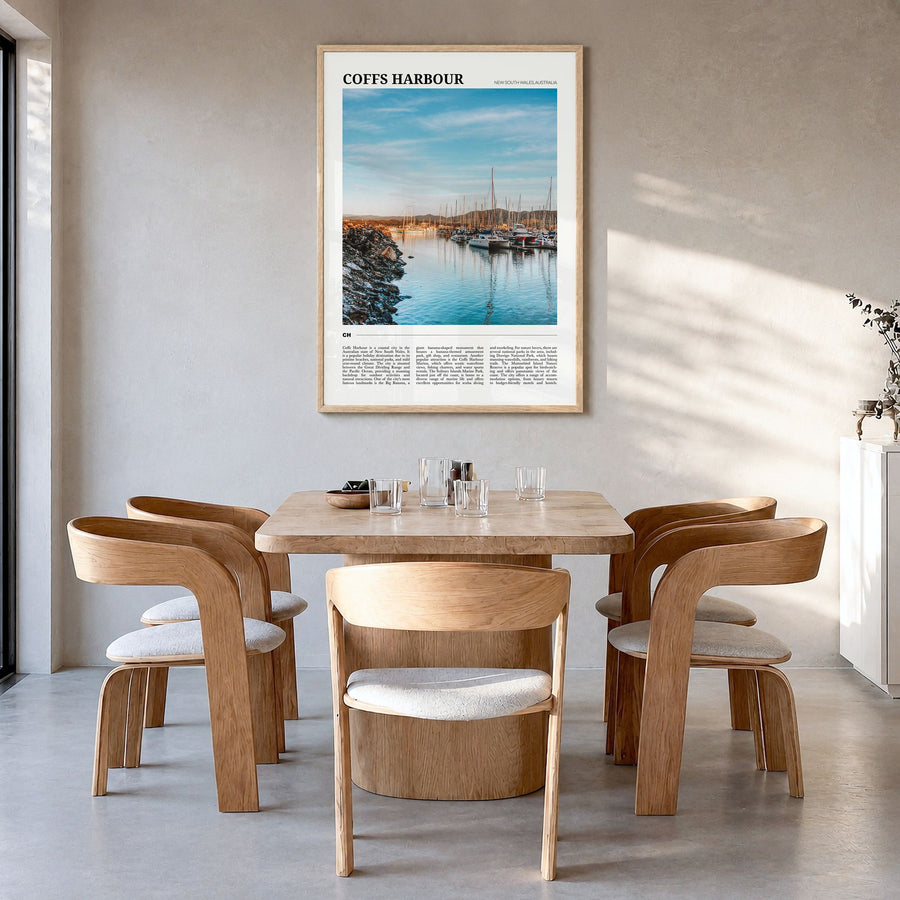 Coffs Harbour Travel Poster in a natural wood frame, hanging in a dining room