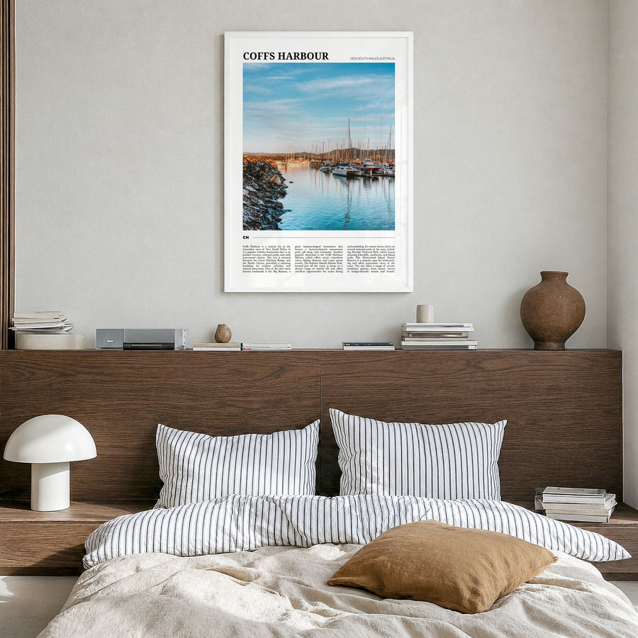 Coffs Harbour Travel Poster in a white wood frame, hanging in a bedroom