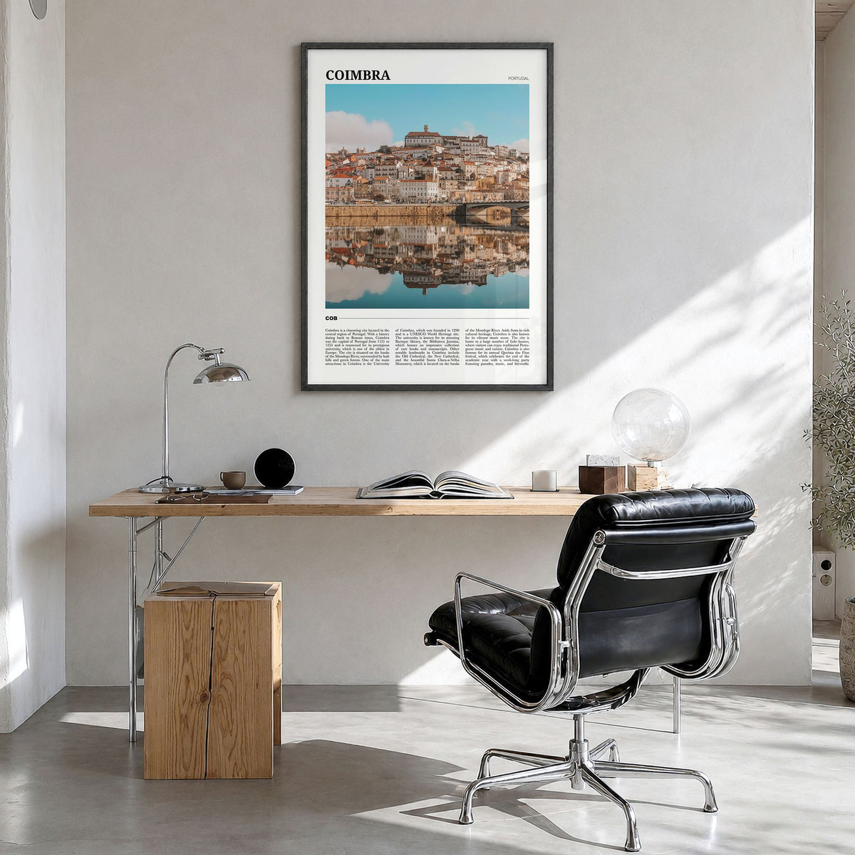 Coimbra Travel Poster in a black wood frame, hanging in a bright home office