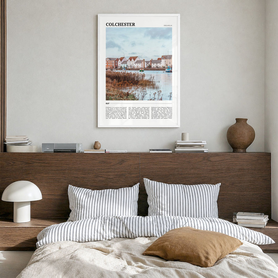 Colchester Travel Poster in a white wood frame, hanging in a bedroom