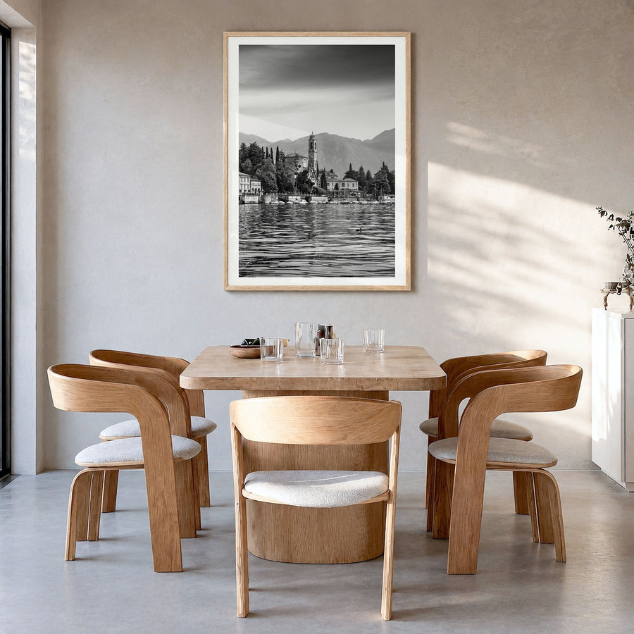 Lake Como Photo No 1 Poster in a natural wood frame, hanging in a dining room, white border