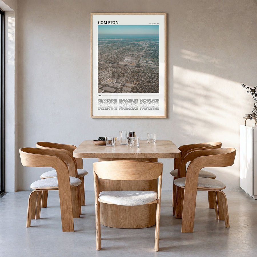Compton Travel Poster in a natural wood frame, hanging in a dining room