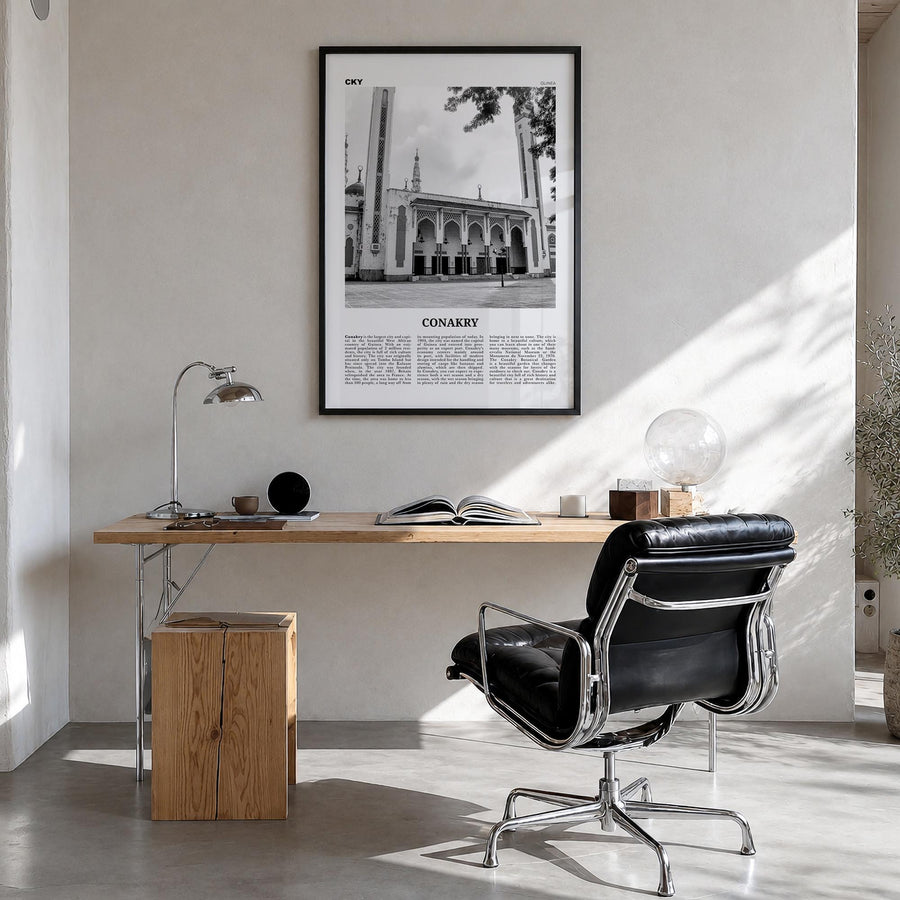 Conakry black & white newspaper poster of Guinea – vertical wall art in black wood frame, hanging on wall