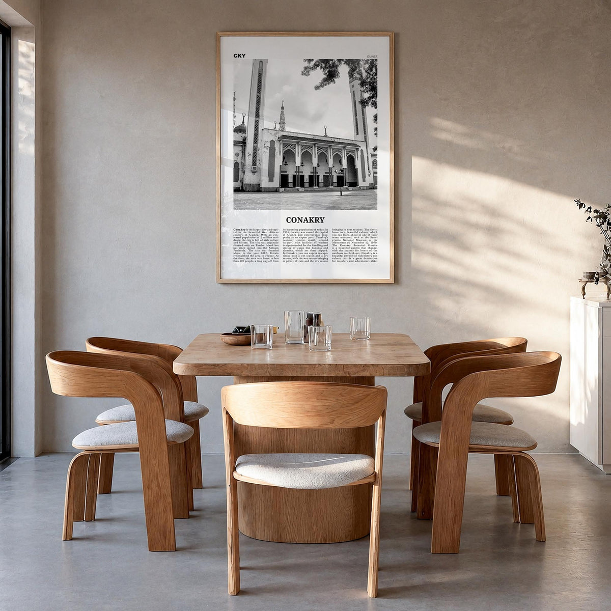 Conakry black & white newspaper poster of Guinea – vertical wall art in natural wood frame, hanging on wall