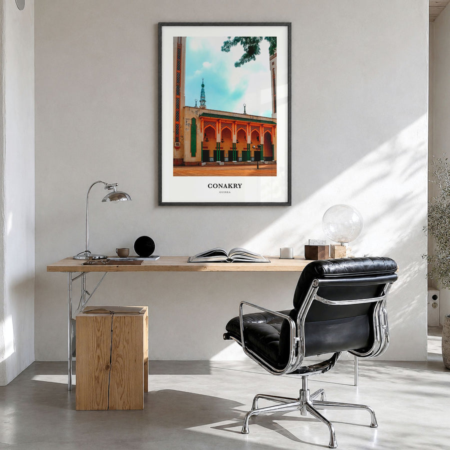 Conakry Classic Poster in a black wood frame, hanging in a bright home office