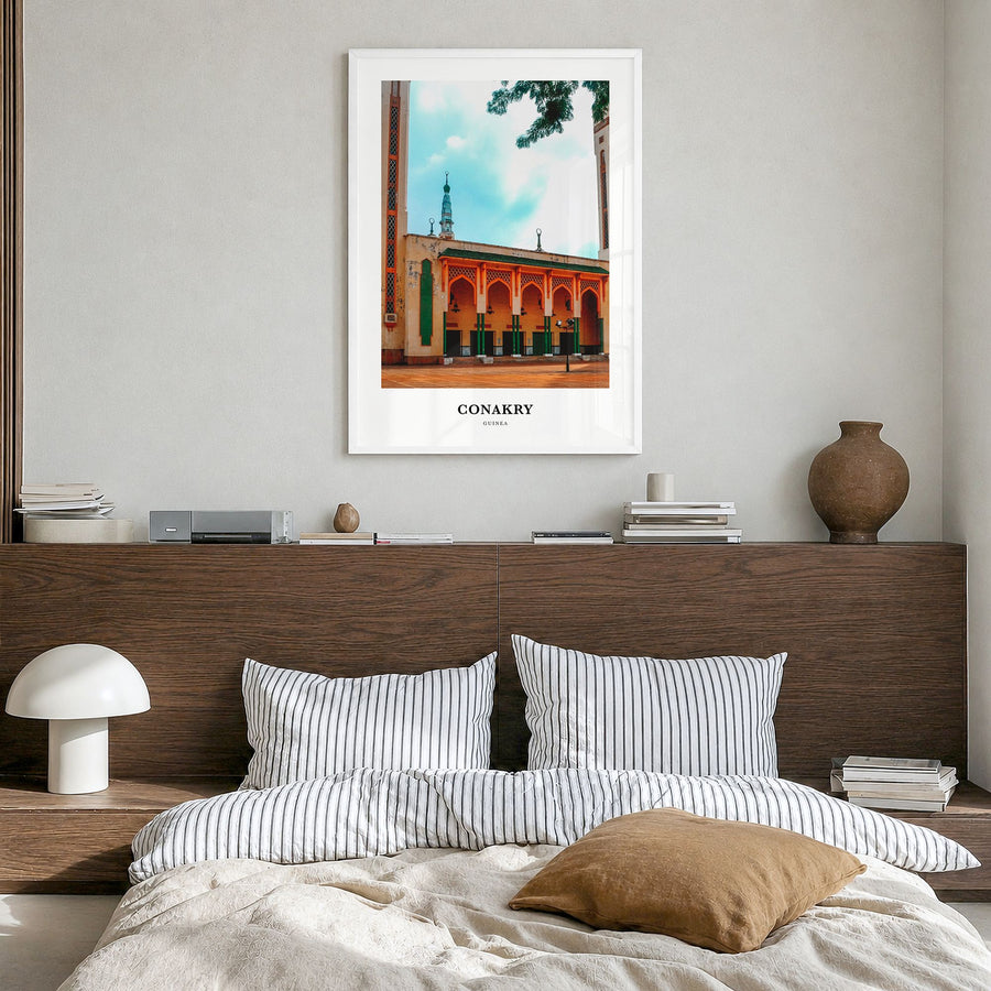 Conakry Classic Poster in a white wood frame, hanging in a bedroom