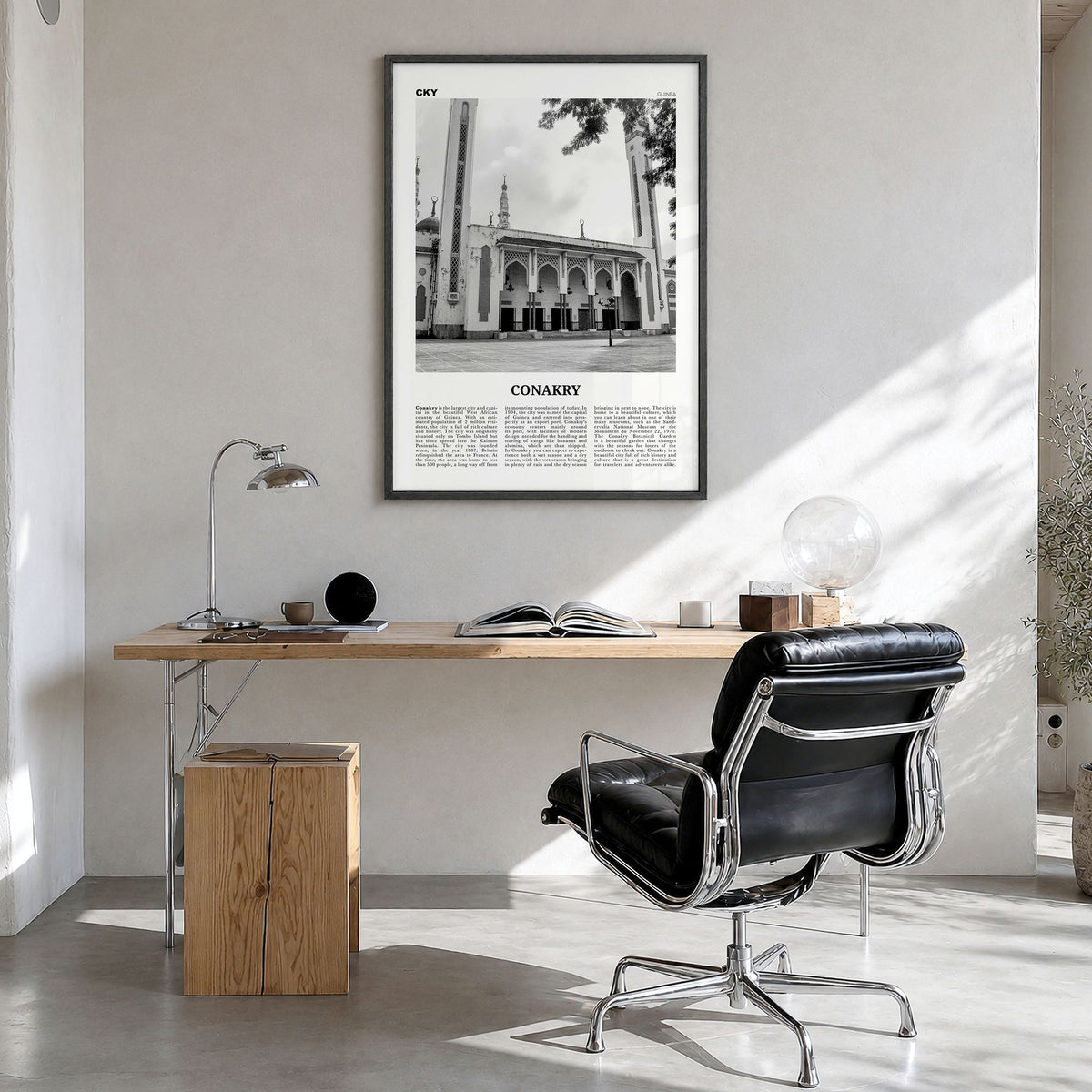 Conakry Newspaper Poster in a black wood frame, hanging in a bright home office