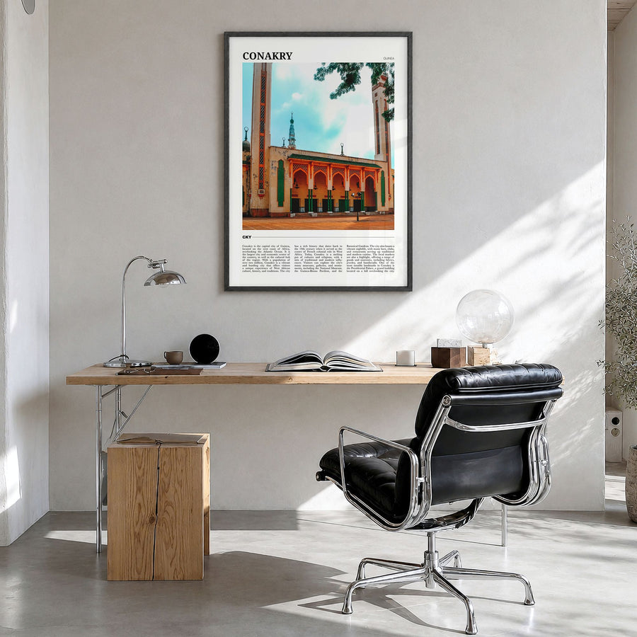 Conakry Travel Poster in a black wood frame, hanging in a bright home office