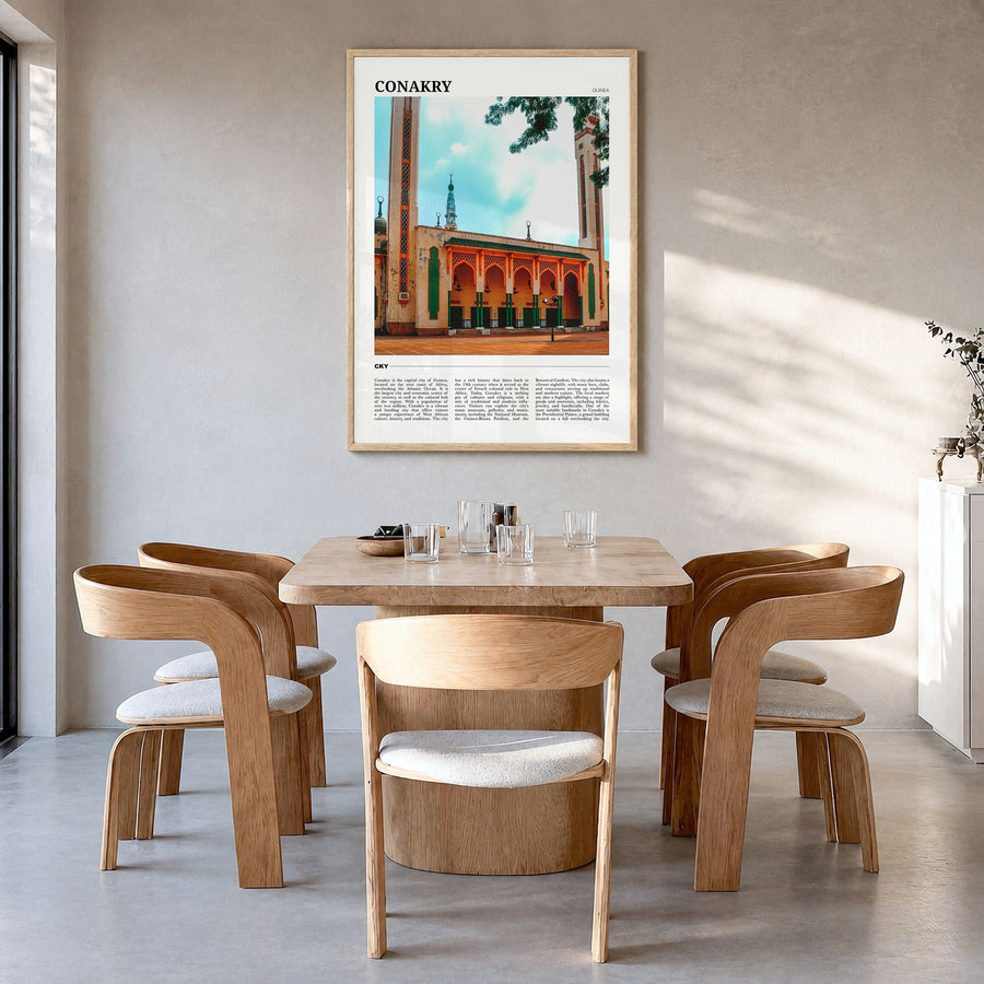 Conakry Travel Poster in a natural wood frame, hanging in a dining room