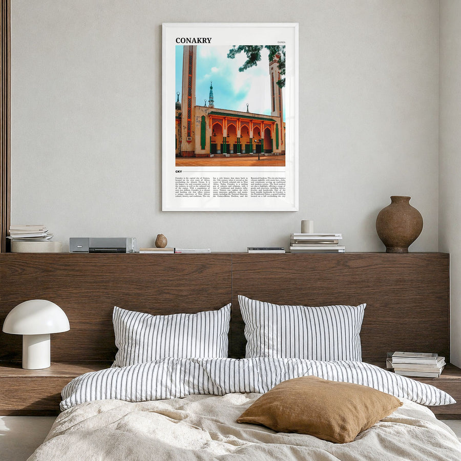 Conakry Travel Poster in a white wood frame, hanging in a bedroom