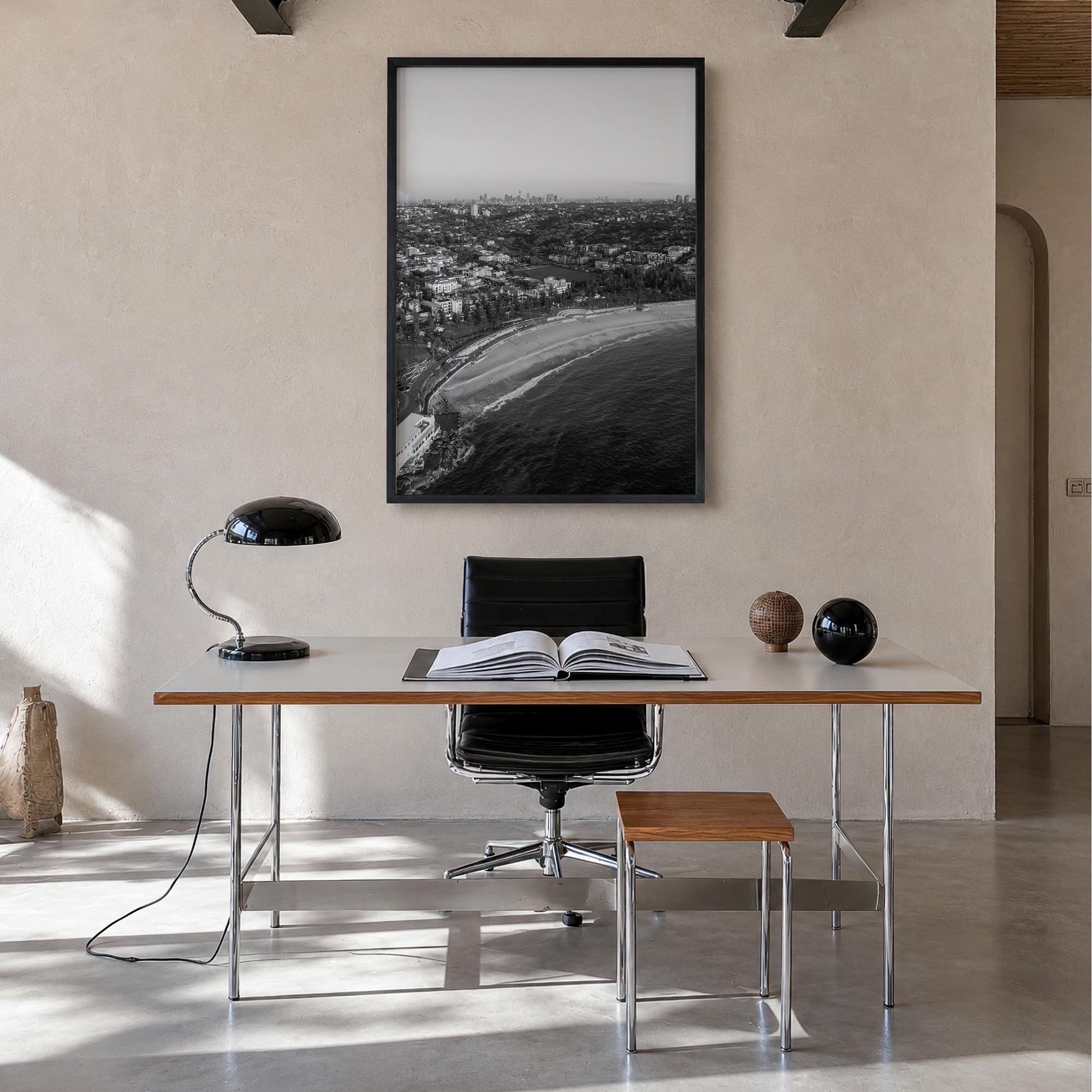 Coogee Beach black & white photo poster of Sydney, New South Wales – vertical wall art in black wood frame, hanging on wall